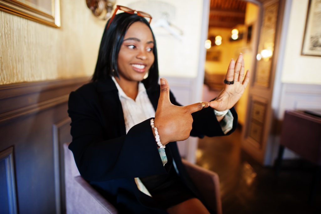 Young woman using sign language.