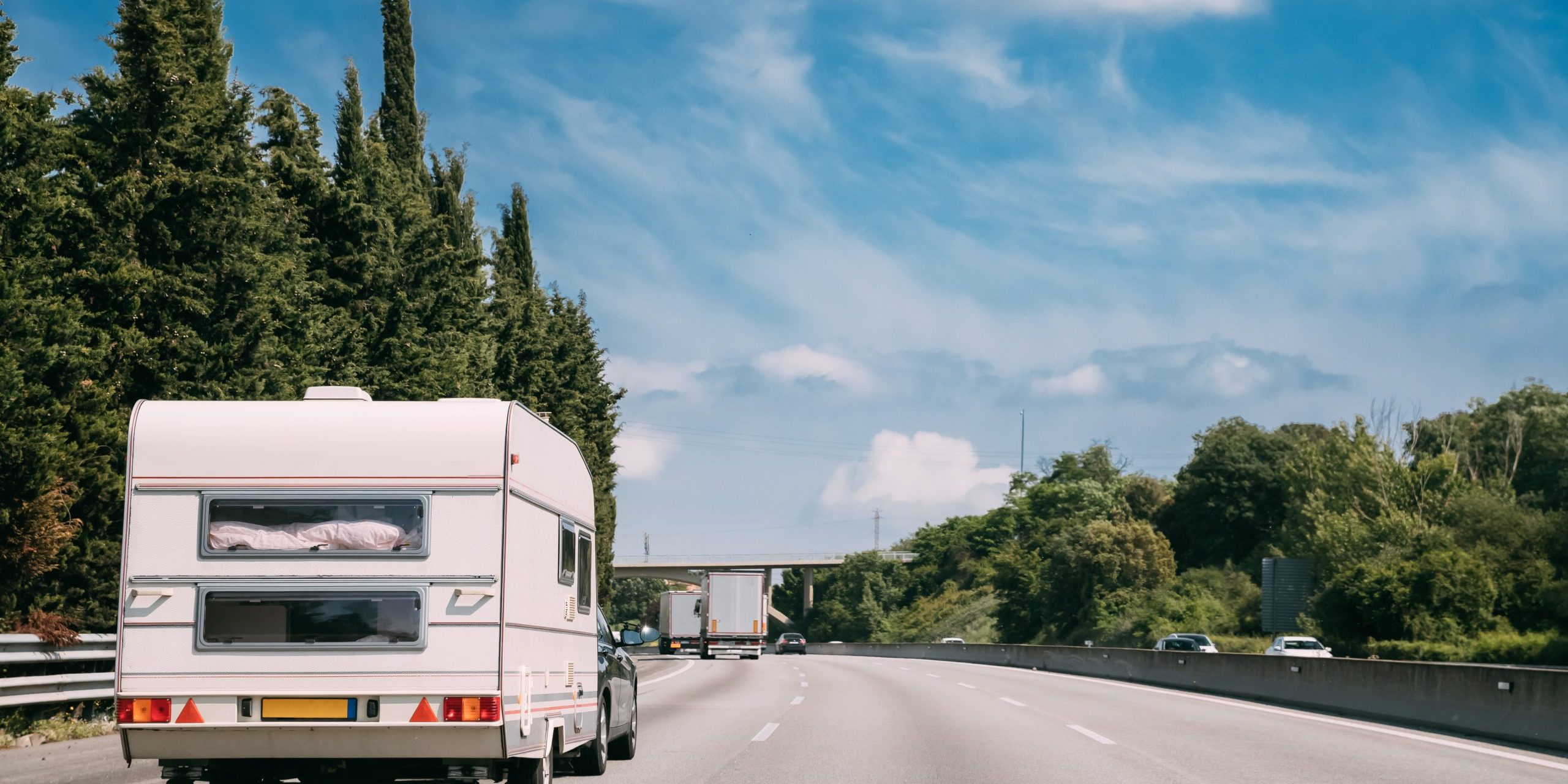 White Caravan Motorhome Car Goes On Highway Road.
